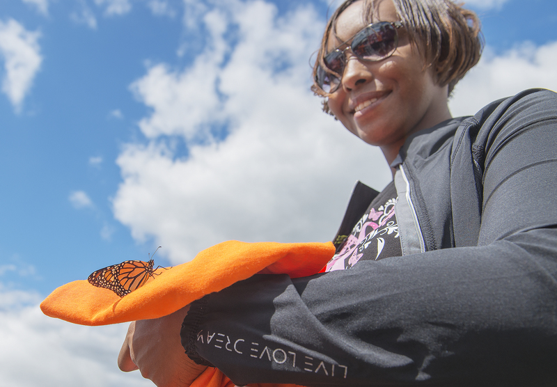 Latrinka Lee, outreach coordinator for Cancer Support Community, watches as her butterfly hangs around. BY DENY HOWETH